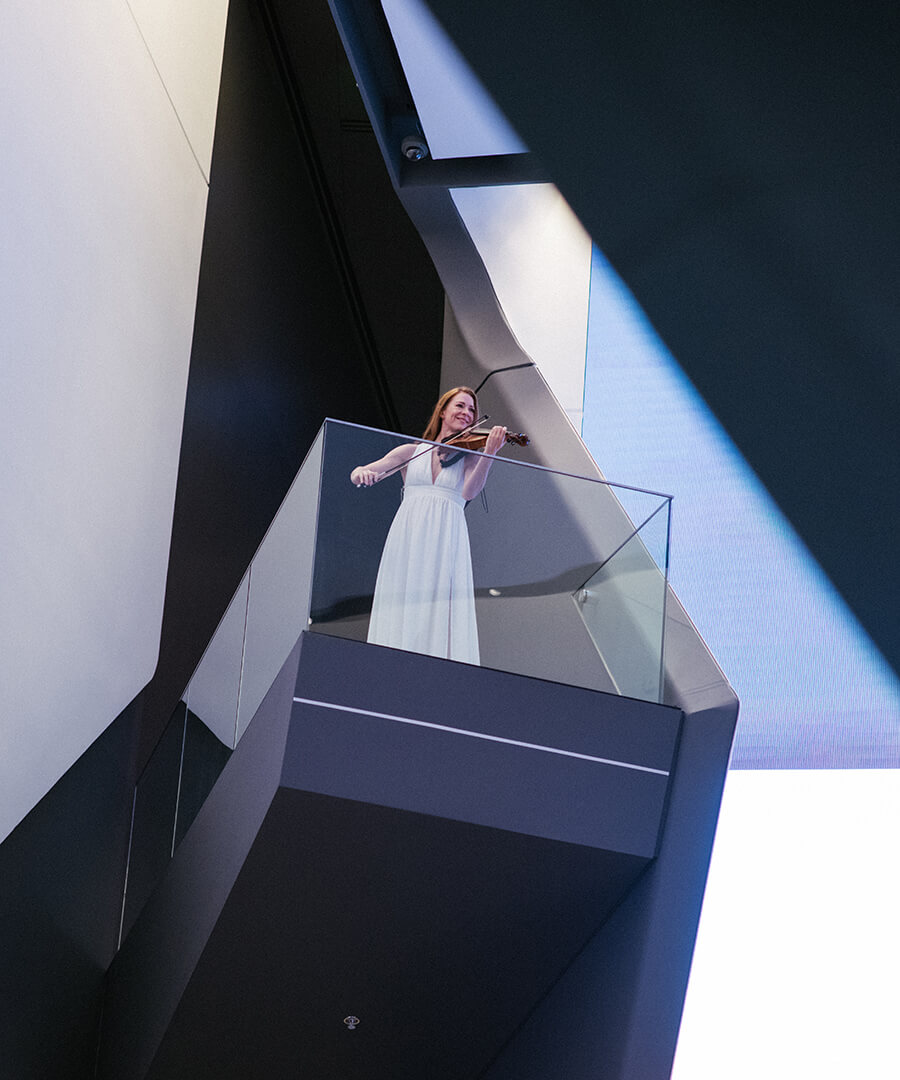 Woman playing violin on balcony
