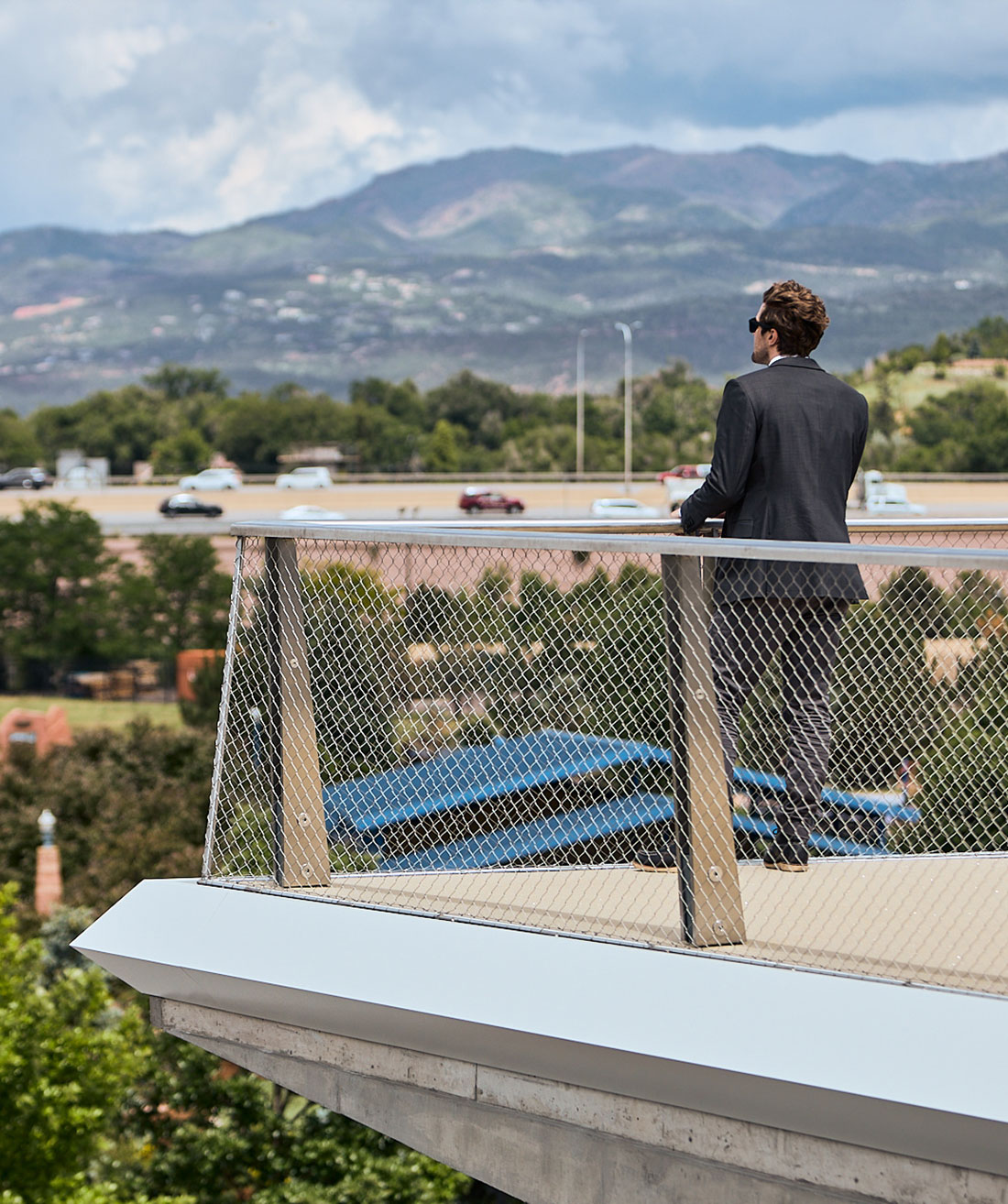 Man standing looking at scenery of walking bridge